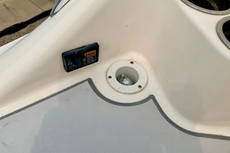 Slide: The Image of Close-up of a 2012 Bryant 268 boat interior detail with warning label and cup holder. - 26