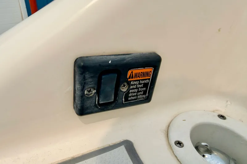 Slide: The Image of Warning label on a 2012 Bryant 268 boat, cautioning about drive unit tilting. - 29