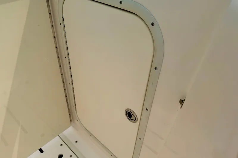 Slide: The Image of 2012 Bryant 268 boat compartment door, white with metal trim and handle. - 74