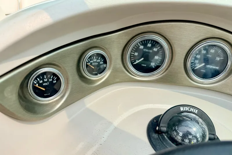 Slide: The Image of Dashboard of a 2012 Bryant 268 boat with gauges and compass. - 53