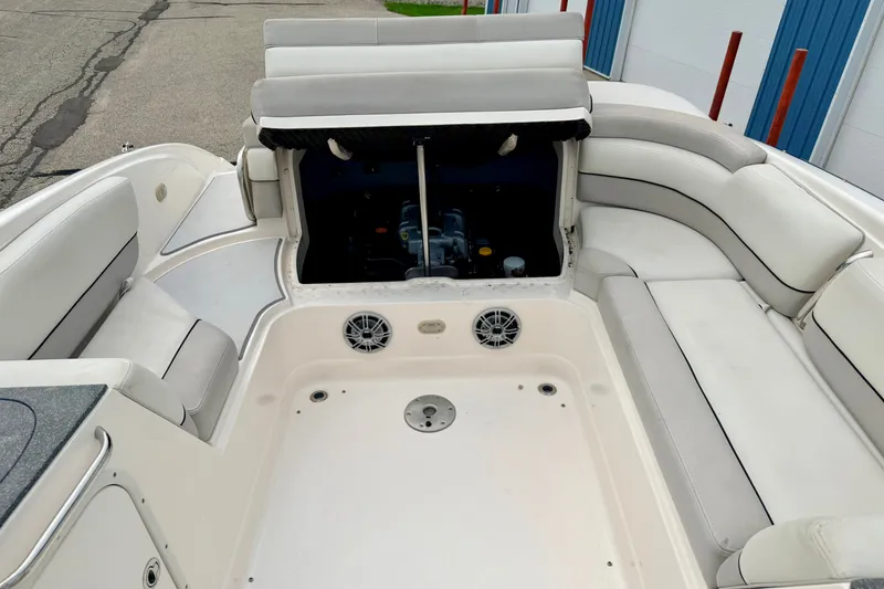 Slide: The Image of 2012 Bryant 268 boat interior with open engine compartment and white seating. - 38