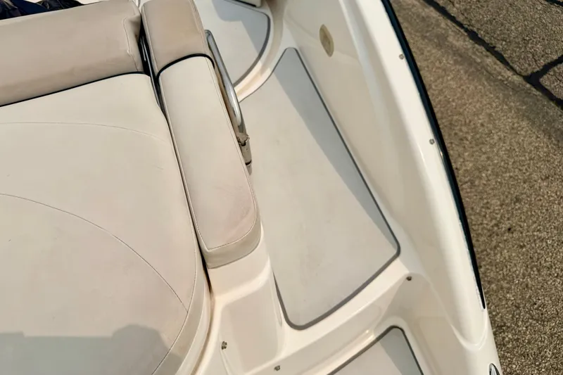 Slide: The Image of Interior view of a 2012 Bryant 268 boat, featuring beige seating and flooring. - 30