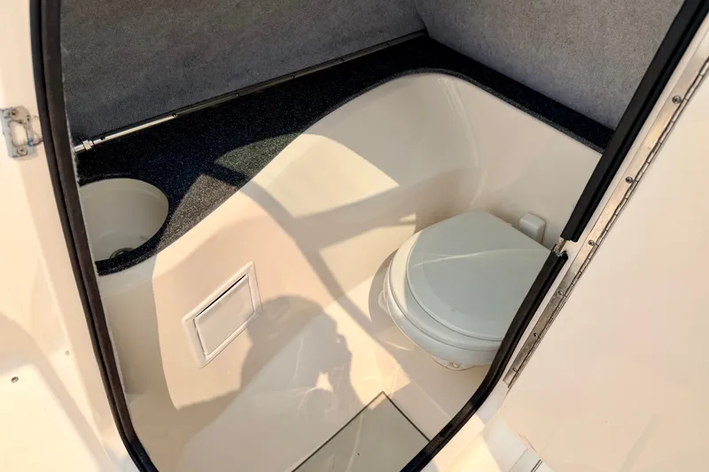 Slide: The Image of Interior of a 2012 Bryant 268 boat bathroom with toilet and storage compartment. - 65