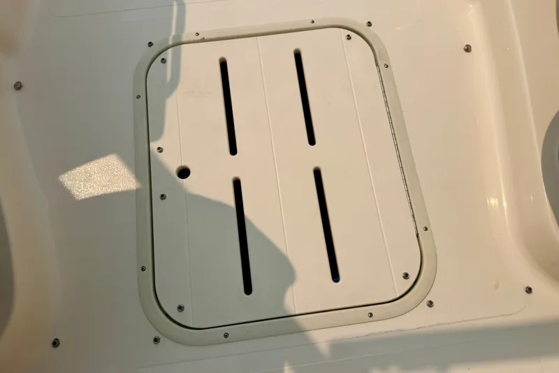 Slide: The Image of Hatch cover on a 2012 Bryant 268 boat deck, featuring ventilation slots. - 68