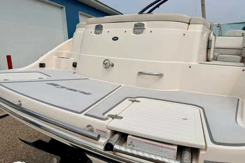 Slide: The Image of Rear view of a 2012 Bryant 268 boat, showcasing swim platform and seating area. - 21