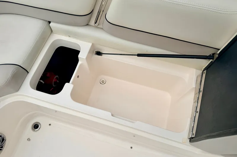 Slide: The Image of Open storage compartment in a 2012 Bryant 268 boat with white interior. - 41