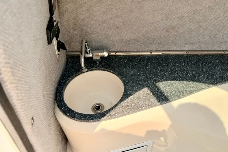 Slide: The Image of Compact sink area in a 2012 Bryant 268 boat interior. - 66