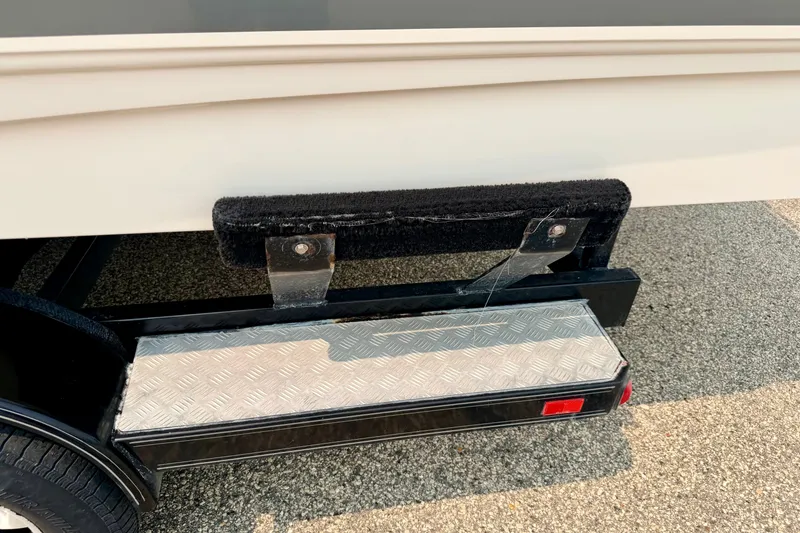 Slide: The Image of 2012 Bryant 268 boat trailer step with textured metal surface and protective padding. - 111