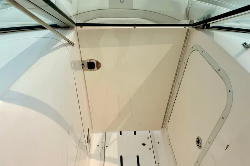 Slide: The Image of 2012 Bryant 268 boat interior with white paneling and storage compartment. - 73