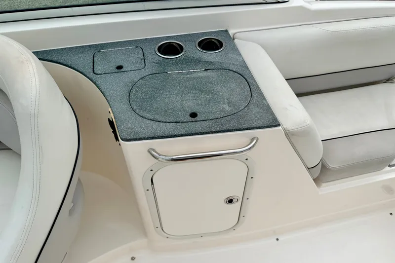 Slide: The Image of Interior of a 2012 Bryant 268 boat featuring a sleek seating area and storage compartment. - 43