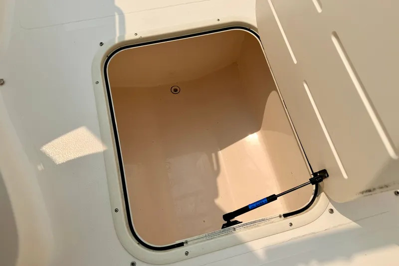 Slide: The Image of Open storage compartment on a 2012 Bryant 268 boat, featuring a hydraulic lift. - 69