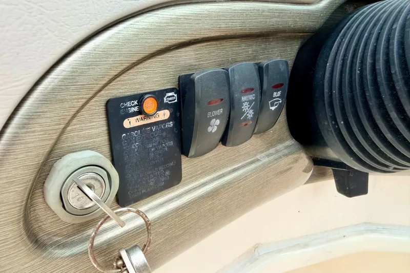Slide: The Image of Control panel of a 2012 Bryant 268 boat with ignition and warning indicators. - 56