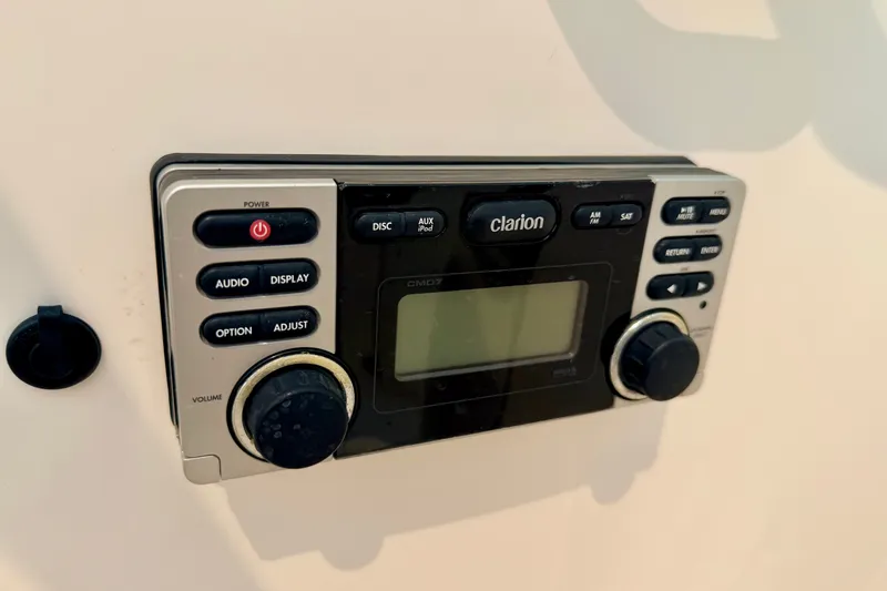 Slide: The Image of Clarion audio system in a 2012 Bryant 268 boat, featuring control buttons and display. - 63