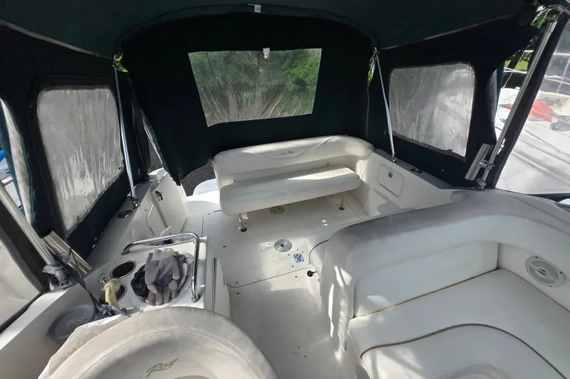 Slide: The Image of 2001 Sea Ray Sundancer 260 interior with seating and covered canopy. - 3