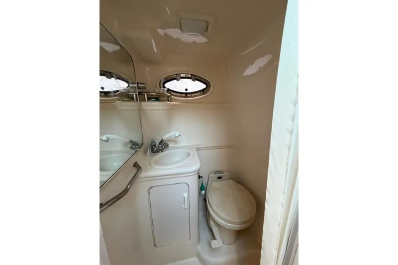 Slide: The Image of 2001 Sea Ray Sundancer 260 bathroom with sink, toilet, and mirror. - 6