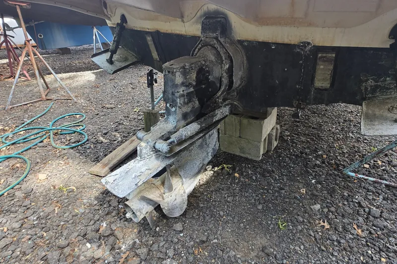 Slide: The Image of 2001 Sea Ray Sundancer 260 boat outdrive on blocks, showing wear and corrosion. - 16
