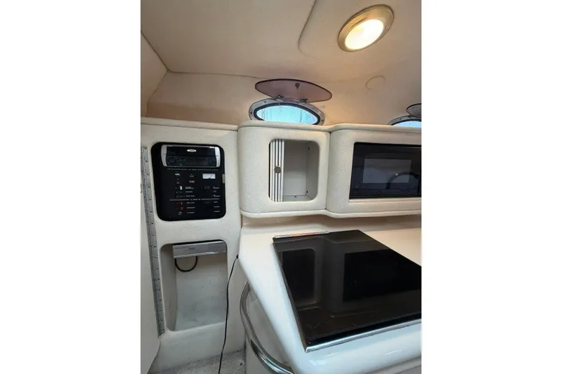 Slide: The Image of 2001 Sea Ray Sundancer 260 cabin interior with control panel and storage compartments. - 9