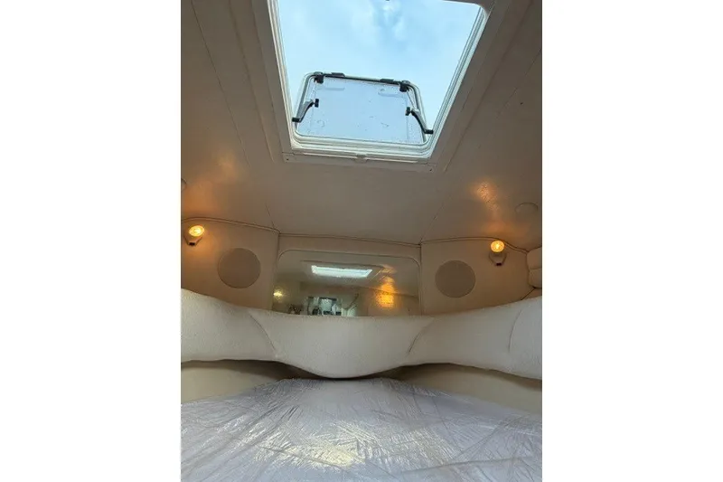 Slide: The Image of Interior cabin view of 2001 Sea Ray Sundancer 260 with skylight and cozy lighting. - 10