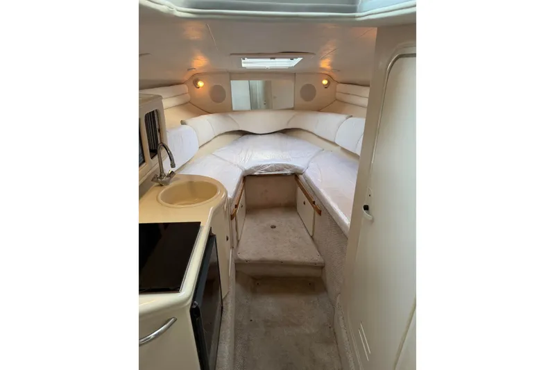 Slide: The Image of Interior of 2001 Sea Ray Sundancer 260 boat with cozy cabin and kitchenette. - 1