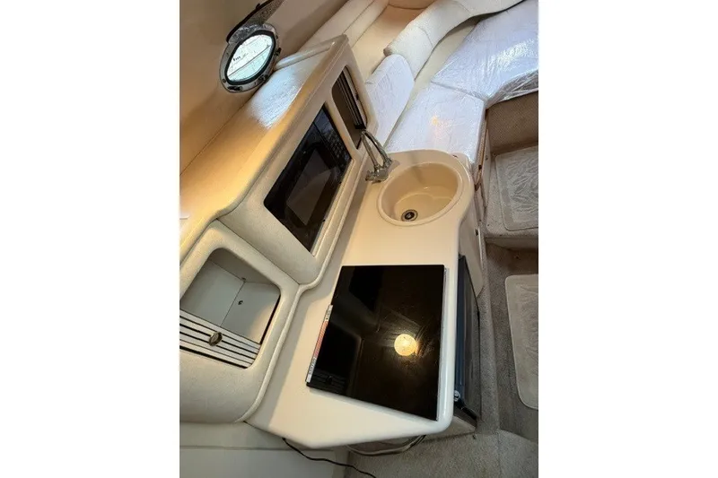 Slide: The Image of 2001 Sea Ray Sundancer 260 cabin interior with kitchenette and sink. - 5