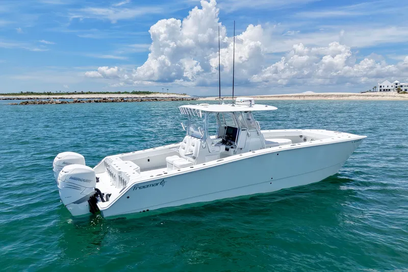 The Image of 2018 Freeman 34VH boat on clear blue water under a partly cloudy sky. - 0