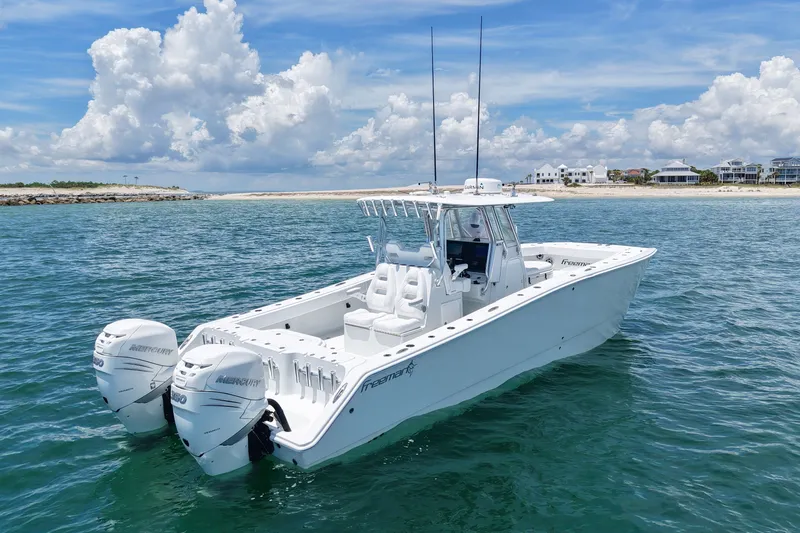 Slide: The Image of 2018 Freeman 34VH boat on open water with clear skies and distant shoreline. - 10
