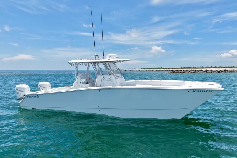 Slide: The Image of 2018 Freeman 34VH boat on clear blue water under a sunny sky. - 18