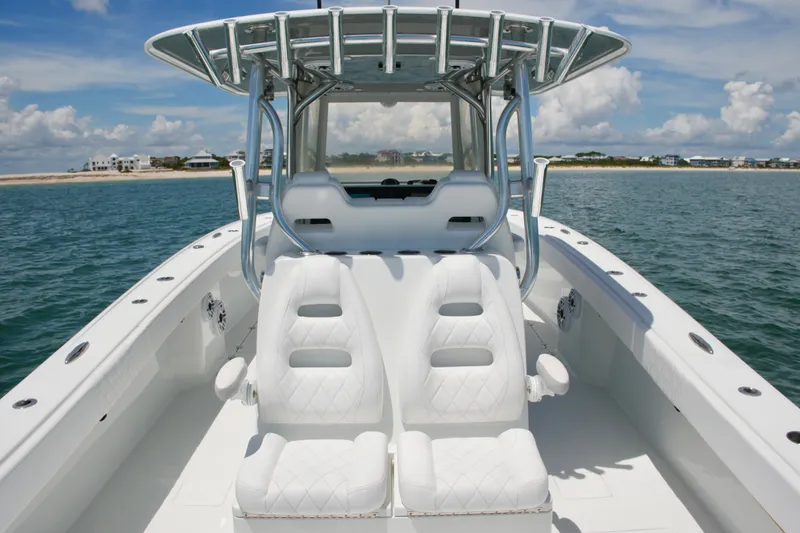 Slide: The Image of 2018 Freeman 34VH boat with white seating, ocean view, and clear sky. - 58