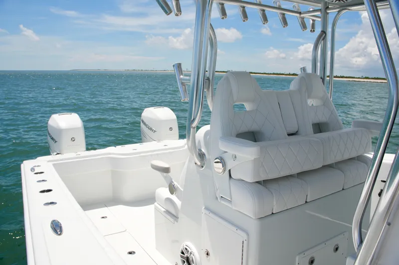 Slide: The Image of 2018 Freeman 34VH boat with white seating, dual Mercury engines, on open water. - 45