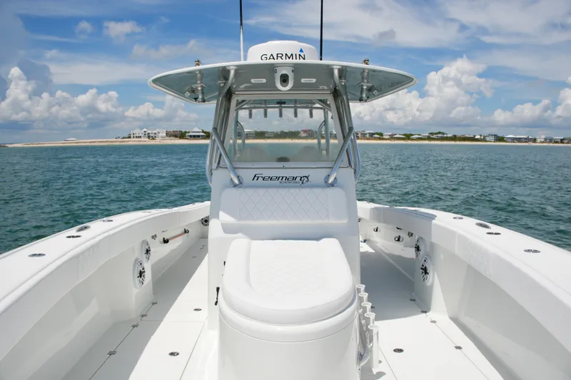 Slide: The Image of 2018 Freeman 34VH boat on open water, featuring Garmin equipment and sleek design. - 41
