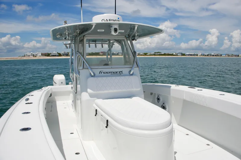 Slide: The Image of 2018 Freeman 34VH boat on water, featuring sleek design and spacious deck. - 39