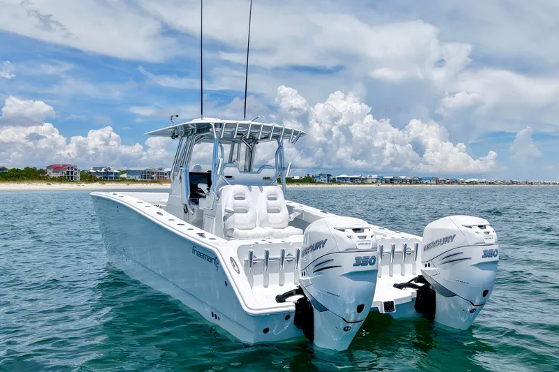 Slide: The Image of 2018 Freeman 34VH boat with twin Mercury 350 engines on open water. - 6