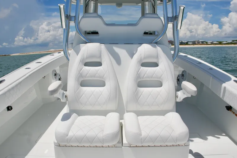 Slide: The Image of Luxurious seating on a 2018 Freeman 34VH boat, with ocean backdrop and clear skies. - 56