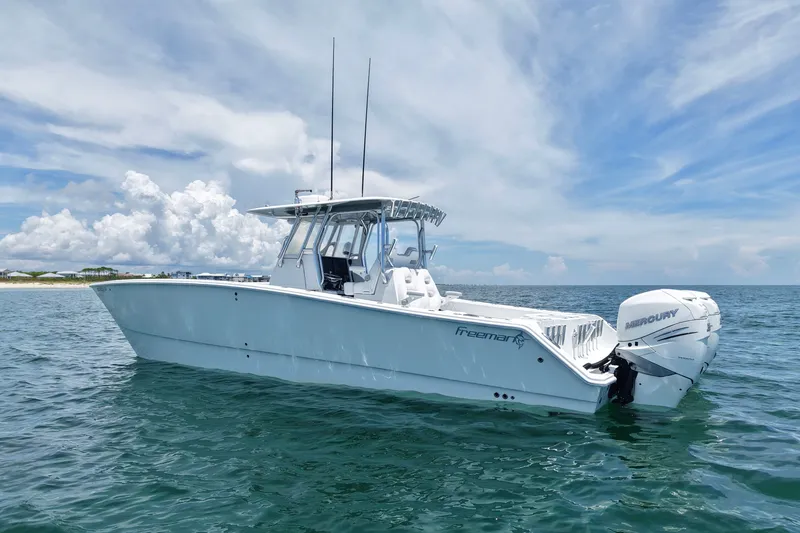 Slide: The Image of 2018 Freeman 34VH boat on calm ocean with clear skies and clouds. - 3