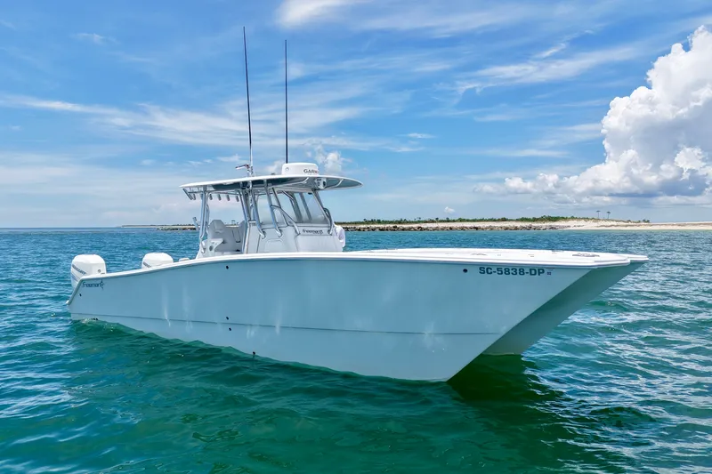 Slide: The Image of 2018 Freeman 34VH boat on calm ocean waters under a clear blue sky. - 15