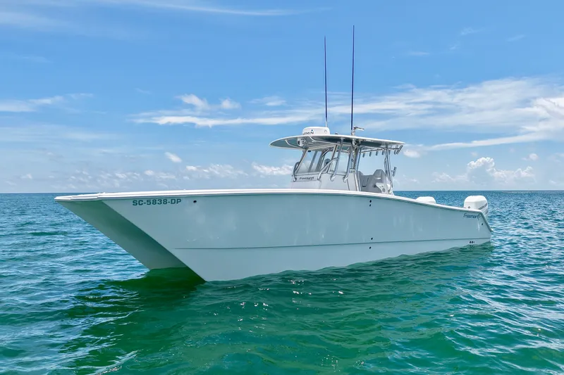 Slide: The Image of 2018 Freeman 34VH boat on calm ocean waters under a clear blue sky. - 35