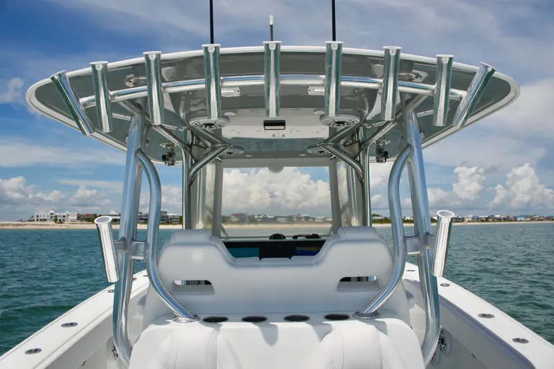 Slide: The Image of 2018 Freeman 34VH boat with sleek design, rod holders, and ocean backdrop. - 59