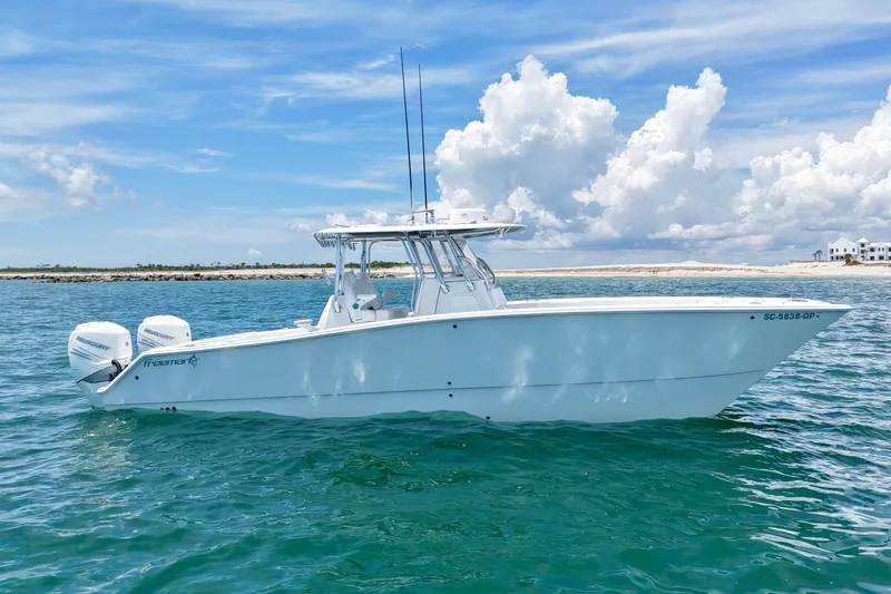 Slide: The Image of 2018 Freeman 34VH boat on clear blue water under a partly cloudy sky. - 13