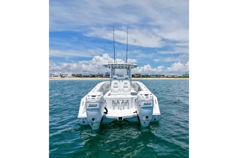 Slide: The Image of 2018 Freeman 34VH boat on water with twin 350 engines, coastal background. - 7