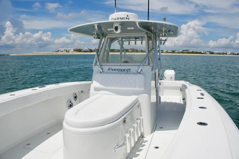 Slide: The Image of 2018 Freeman 34VH boat on calm waters, featuring sleek design and spacious deck. - 42