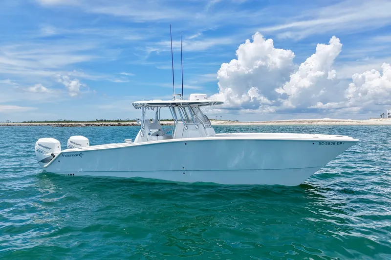 Slide: The Image of 2018 Freeman 34VH boat on clear blue water under a partly cloudy sky. - 14