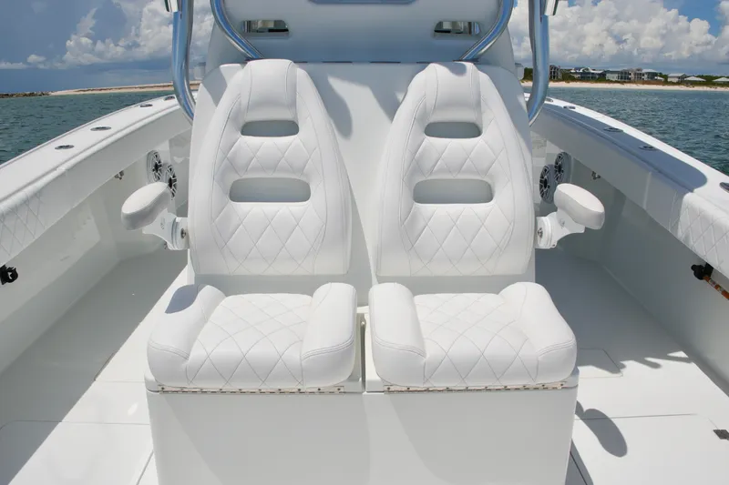 Slide: The Image of Luxurious white seating on a 2018 Freeman 34VH boat, with ocean backdrop. - 55