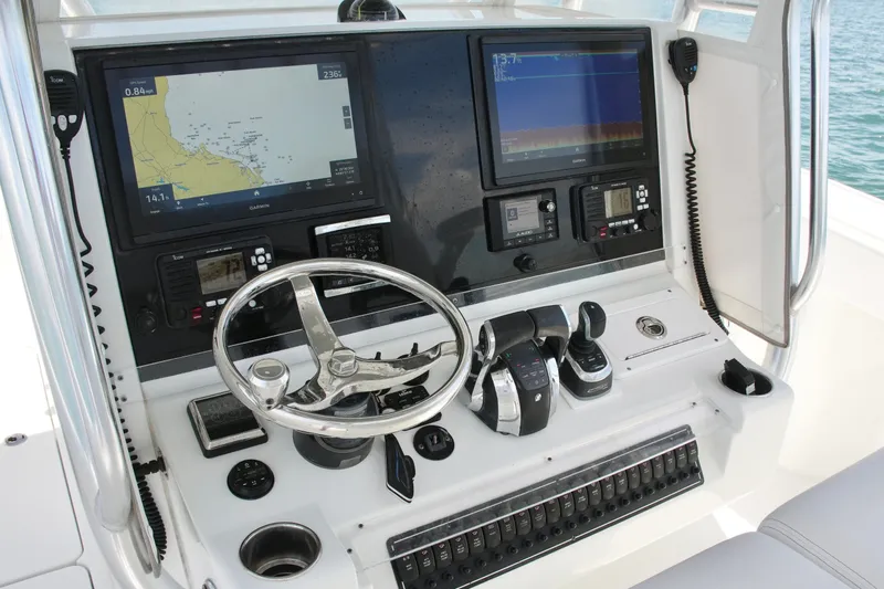 Slide: The Image of Control panel of a 2018 Freeman 34VH boat with navigation screens and steering wheel. - 49