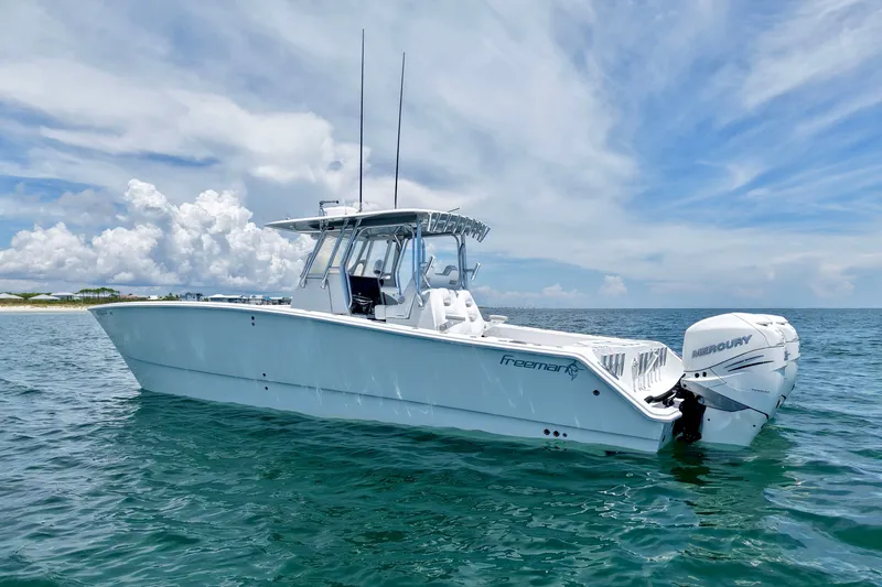 Slide: The Image of 2018 Freeman 34VH boat on open water with clear skies and twin Mercury engines. - 4