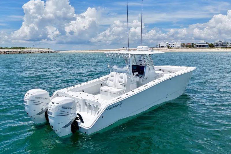 Slide: The Image of A 2018 Freeman 34VH boat with twin Mercury engines on open water. - 11