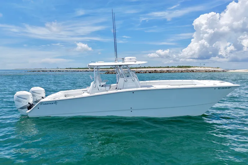 Slide: The Image of 2018 Freeman 34VH boat on clear blue water under a bright sky. - 17
