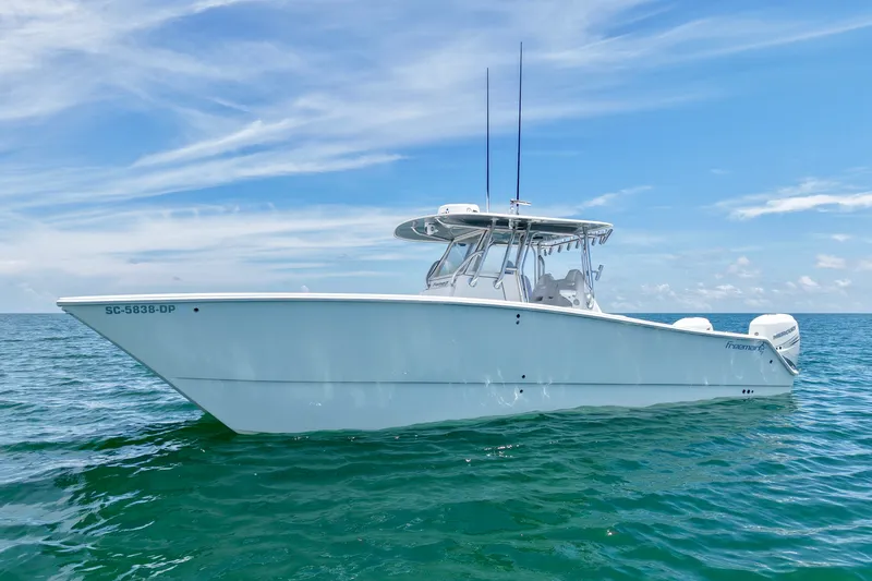 Slide: The Image of 2018 Freeman 34VH boat on open water under a clear blue sky. - 2