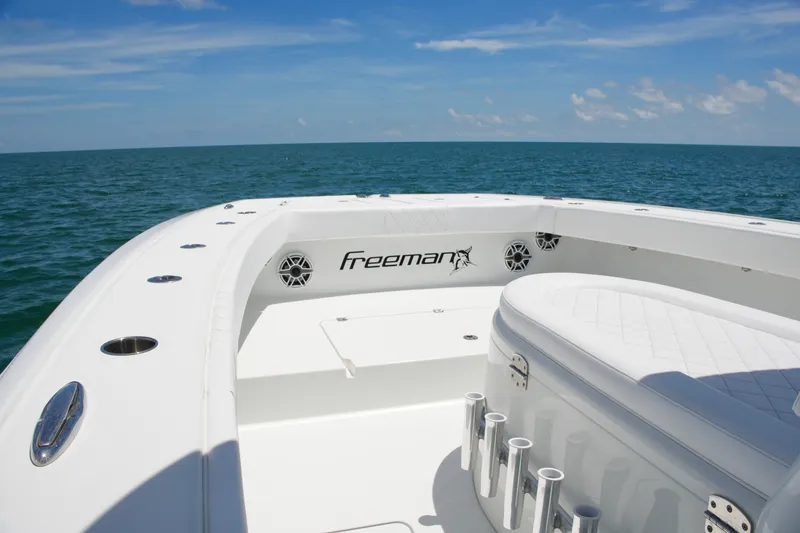Slide: The Image of Freeman 34VH 2018 boat on open sea, featuring sleek white deck design. - 37
