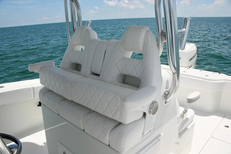 Slide: The Image of Luxurious white seating on a 2018 Freeman 34VH boat, ocean backdrop. - 48