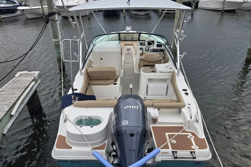Slide: The Image of 2020 NauticStar 2302 Legacy Dual Console boat docked at marina. - 1